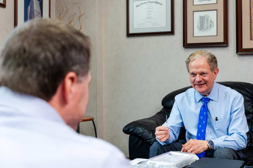 A male patient sits across from a mental health therapist in Newburgh in an office